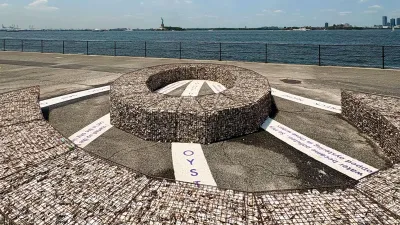 View of a sculptural installation of wire cages filled with oyster shells with the Statue of Liberty visible in the background.